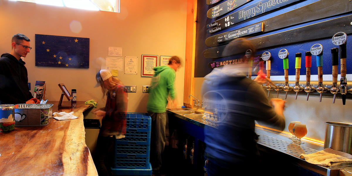 girdwood brewery staff hard at work pouring beer
